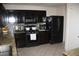 Stylish kitchen features dark cabinetry, granite counters, and stainless steel appliances at 5381 Awbury Ave, Las Vegas, NV 89110