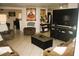 Relax in this cozy living room complete with tile flooring, comfortable couches, and a large tv at 5381 Awbury Ave, Las Vegas, NV 89110