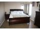 Bright and spacious main bedroom suite features a king bed and tile flooring at 5381 Awbury Ave, Las Vegas, NV 89110