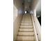 Tiled staircase leads to the upper level of the home and features white risers and a light wood banister at 5381 Awbury Ave, Las Vegas, NV 89110