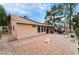 Spacious backyard with stone landscaping, solar panels, covered patio, and comfortable outdoor living space at 5528 Apache Wells Way, Las Vegas, NV 89130