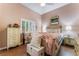 Cozy bedroom featuring a comfortable bed, shuttered windows, and stylish furnishings at 5528 Apache Wells Way, Las Vegas, NV 89130