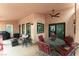 Inviting covered patio features an outdoor seating area, ceiling fan and tile flooring, perfect for relaxing at 5528 Apache Wells Way, Las Vegas, NV 89130