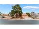 Charming single-story home with well-maintained landscaping, mature trees, and inviting curb appeal at 5528 Apache Wells Way, Las Vegas, NV 89130