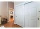 Hallway featuring closet, wood floors, and access to bedrooms at 5528 Apache Wells Way, Las Vegas, NV 89130
