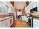 Well-equipped kitchen with stainless steel appliances, granite countertops, and white cabinetry at 5528 Apache Wells Way, Las Vegas, NV 89130