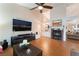Comfortable living room with high ceilings, wood-look flooring and stone fireplace at 5528 Apache Wells Way, Las Vegas, NV 89130