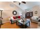 Spacious living room with vaulted ceilings, wood-look flooring, and ample seating at 5528 Apache Wells Way, Las Vegas, NV 89130