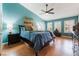 Comfortable main bedroom featuring vaulted ceiling, wood-look floors, and ample natural light at 5528 Apache Wells Way, Las Vegas, NV 89130