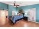 Comfortable main bedroom featuring vaulted ceiling, wood-look floors, and ample natural light at 5528 Apache Wells Way, Las Vegas, NV 89130