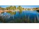 Scenic community pond with a fountain, grassy edges, and lush foliage creating a serene and picturesque setting at 5528 Apache Wells Way, Las Vegas, NV 89130