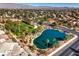 Aerial shot of community featuring a lush golf course, pond, and mature landscaping at 5604 Ocean Pines Cir, Las Vegas, NV 89130
