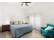 Bedroom with wood floors, a comfortable bed, bedside tables, and an accent chair offering a calming retreat at 5604 Ocean Pines Cir, Las Vegas, NV 89130