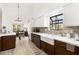 Well-lit kitchen with two-tone cabinets, farmhouse sink, and stainless steel appliances; open concept design at 5604 Ocean Pines Cir, Las Vegas, NV 89130