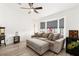 Comfortable living room with neutral tones, large bay window, wood floors, ceiling fan, and modern decor at 5604 Ocean Pines Cir, Las Vegas, NV 89130