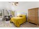 Cozy bedroom with wood flooring, a ceiling fan, and a comfortable seating area by the windows at 5604 Ocean Pines Cir, Las Vegas, NV 89130