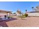 Expansive backyard featuring artificial turf, a covered patio, and drought-resistant landscaping at 5927 Tropical Palm Ct, North Las Vegas, NV 89031
