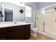 Well-lit bathroom with glass enclosed shower and vanity with neutral counter at 5927 Tropical Palm Ct, North Las Vegas, NV 89031