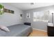 Cozy bedroom with tile floors, light grey walls, and a sunny window at 5927 Tropical Palm Ct, North Las Vegas, NV 89031