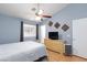Spacious bedroom with ceiling fan, dresser, tile floors, and closet at 5927 Tropical Palm Ct, North Las Vegas, NV 89031