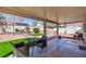 Relaxing covered patio overlooking the backyard with low-maintenance landscaping and seating at 5927 Tropical Palm Ct, North Las Vegas, NV 89031