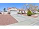 Charming single-story home featuring a two-car garage and desert landscaping at 5927 Tropical Palm Ct, North Las Vegas, NV 89031