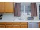 Close-up on sink and the details of the kitchen, including wooden cabinets and lots of light at 5927 Tropical Palm Ct, North Las Vegas, NV 89031
