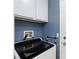 Laundry room with modern washing machine and neutral cabinets at 5927 Tropical Palm Ct, North Las Vegas, NV 89031