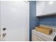 Laundry area with washer and dryer, storage cabinets, and exterior door at 5927 Tropical Palm Ct, North Las Vegas, NV 89031