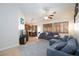 Inviting living room featuring neutral paint, tile floors and a ceiling fan, perfect for relaxing or entertaining guests at 5927 Tropical Palm Ct, North Las Vegas, NV 89031