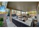 Spacious back patio features comfortable seating, a dining area, and entertainment at 6104 Talbot Springs Ct, North Las Vegas, NV 89081