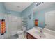 Clean bathroom featuring blue walls, a shower-tub combo, and a vanity with a mirror at 6104 Talbot Springs Ct, North Las Vegas, NV 89081