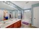 Bright bathroom featuring a double sink vanity and a shower-tub combo at 6104 Talbot Springs Ct, North Las Vegas, NV 89081