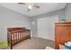 Well-lit bedroom with neutral walls, a closet, and a wooden crib at 6104 Talbot Springs Ct, North Las Vegas, NV 89081