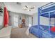 Comfortable bedroom featuring carpet floors, a ceiling fan, and a stylish dresser at 6104 Talbot Springs Ct, North Las Vegas, NV 89081