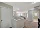 Hallway with carpet and bright light with view of exercise equipment and laundry room at 6104 Talbot Springs Ct, North Las Vegas, NV 89081