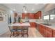 Open concept kitchen with wood cabinets, stainless steel appliances, granite countertops, and a central island with seating at 6104 Talbot Springs Ct, North Las Vegas, NV 89081