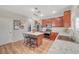 Open concept kitchen with wood cabinets, stainless steel appliances, granite countertops, and a central island with seating at 6104 Talbot Springs Ct, North Las Vegas, NV 89081