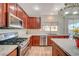 Bright kitchen features stainless appliances, granite counters, and wood cabinets at 6104 Talbot Springs Ct, North Las Vegas, NV 89081