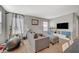 The carpeted living room has plenty of space with great natural light at 6104 Talbot Springs Ct, North Las Vegas, NV 89081
