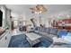 Open floor plan showcasing the living room with a large sectional sofa leading into the dining and kitchen areas at 6104 Talbot Springs Ct, North Las Vegas, NV 89081