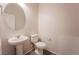 Half bathroom with pedestal sink, toilet, and neutral wall color at 6129 Rose Springs Ave, Las Vegas, NV 89130