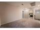 This spacious bonus room features neutral walls, soft carpeting, and adjacent laundry area at 6129 Rose Springs Ave, Las Vegas, NV 89130