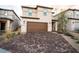 Front exterior view of house featuring a brick driveway and two car garage at 6129 Rose Springs Ave, Las Vegas, NV 89130
