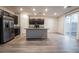 Modern kitchen with stainless steel appliances and center island with granite countertops at 6129 Rose Springs Ave, Las Vegas, NV 89130