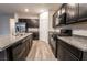 Kitchen boasting dark wood cabinets, granite countertops, and stainless steel appliances at 6129 Rose Springs Ave, Las Vegas, NV 89130