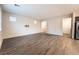 Neutral living room with wood-look floors and ample windows for natural light at 6129 Rose Springs Ave, Las Vegas, NV 89130