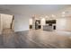 Open-concept living area with wood-look floors leading to a modern kitchen at 6129 Rose Springs Ave, Las Vegas, NV 89130