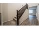 Carpeted staircase with dark wood railings and wood-look flooring in entry way at 6129 Rose Springs Ave, Las Vegas, NV 89130