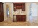 Sophisticated wet bar with custom cabinetry, marble countertop, stainless steel mini fridge, and stylish fixtures at 7261 Obannon Dr, Las Vegas, NV 89117